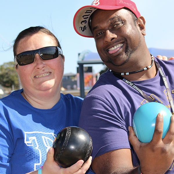 Two people playing lawn bowls