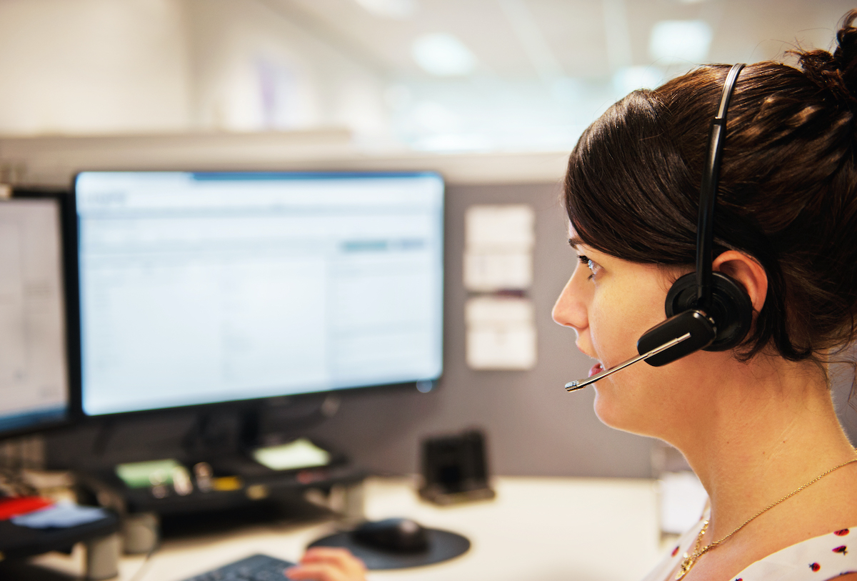 women with headset on working at computer