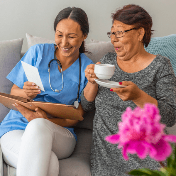 Carer with Individual Connecting with Tea and Photos